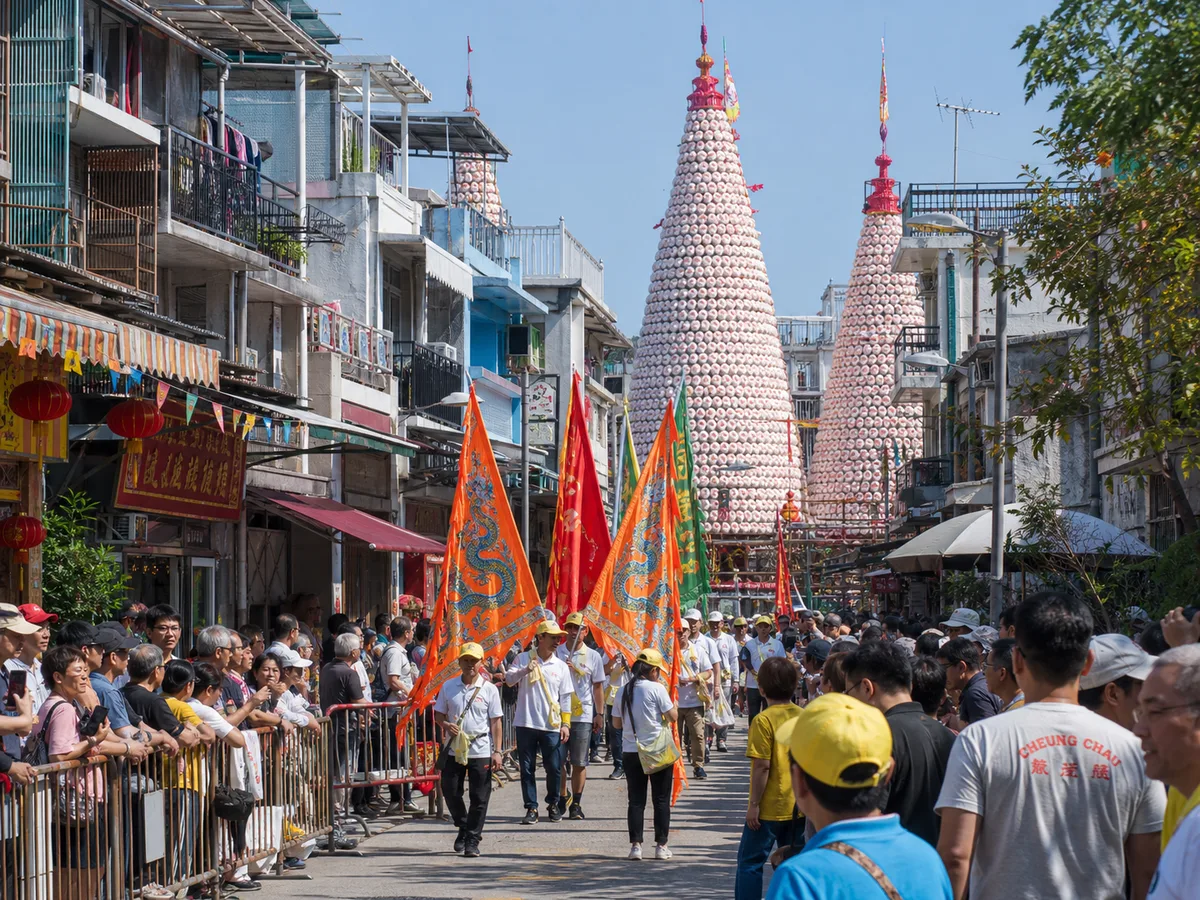Festival banners and peace bun towers during the Cheung Chau Bun Festival.