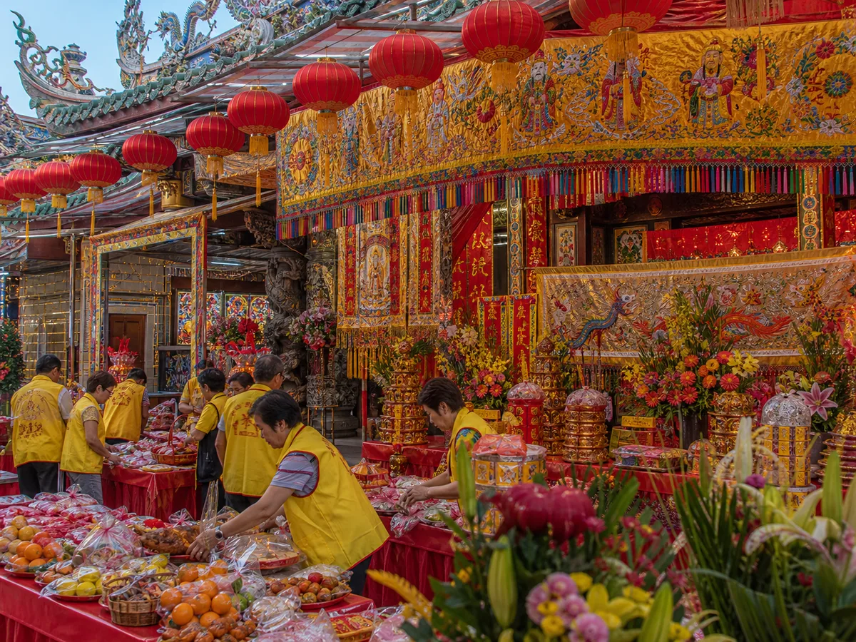 Banners, offerings, and lanterns arranged for a Chinese temple anniversary.